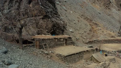 Panning shot of a hut with tree in the mountains of Kalash valley,Pakistan Stock Footage 170350449