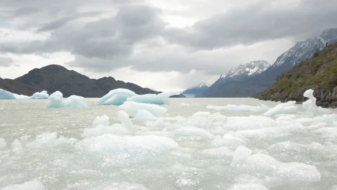 Panning shot of ice and waves in frozen ocean bay, Patagonia, Chile Stock Footage 137958550