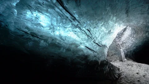 Panning shot inside blue ice cave in land of Breidamerkurjokull, Iceland Stock Footage 120475947
