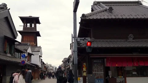 Panning Shot of Kawagoe Clock Tower Street with Visitors in Historic Little Edo Stock Footage 334366851