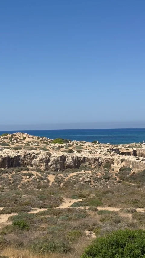 Panning shot from left to right of a scenic limestone coast next to blue ocean Stock Footage 336334019