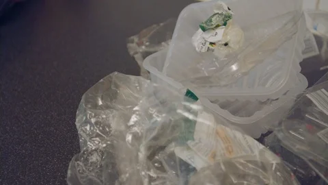 Panning shot of leftover plastic packaging waste Stock Footage 95187365
