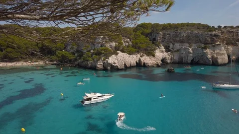 Panning shot looking down onto Cala Macarella beach blue turquoise water Vidéo 128320504