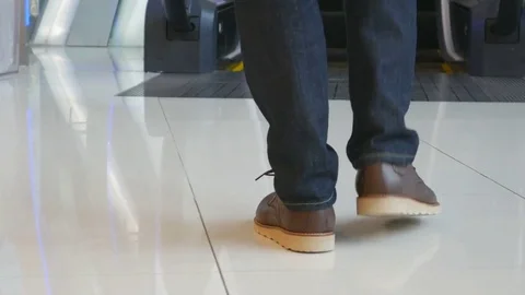Panning shot of A Man on a moving escalator Stock Footage 77652098