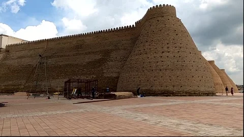Panning shot of the massive mud-brick walls of the Ark of Bukhara Stock Footage 336064275