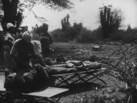Panning shot of men setting up camp, 1940s Stock Footage 65860433