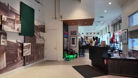 Panning shot of modern retail store interior with reception desk and wall murals Stock Footage 336352102