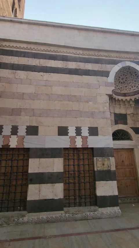 A panning shot of the mosque's stone facade to the main entrance Stock Footage 314314030