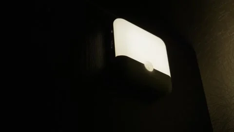 Panning Shot of Motion Sensor Night Light in Dark Hallway Video stock 329558850