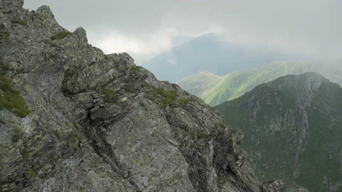 Panning shot of mountain peaks with clouds Stock Footage 138485123