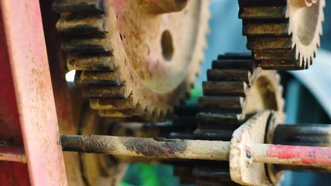 Panning in shot of old rusted gears of a transmission taken with a shallow depth Stock Footage 117026558