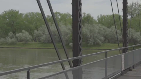 Panning Shot from Old Rusty Bridge to over a River in Rural Montana (Uncolored) Stock Footage 235247605