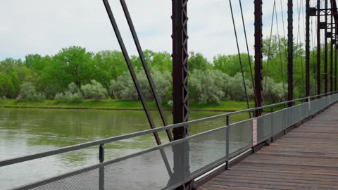 Panning Shot from Old Rusty Bridge to over a River in Rural Montana Stock Footage 235255845