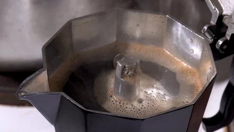 Panning shot over boiling coffee in stove top coffee maker Stock-Footage 88256553