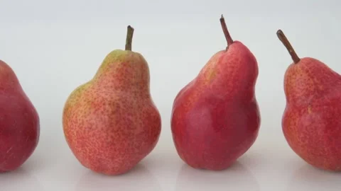 Panning shot over four pears isolated on white Stock Footage 154475972