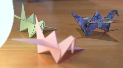 Panning shot of paper cranes in different colour 4K 스톡 동영상 61105709