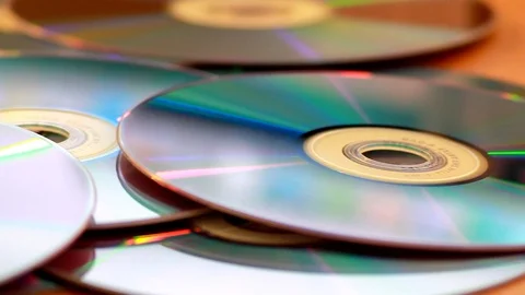 Panning shot of a pile of DVDs on a table 動画素材 92525279