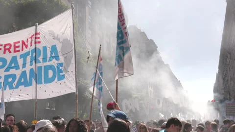 Panning shot of protestors marching on the streets of buenos airies Stock Footage 304265166