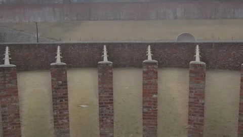 Panning shot of a red brick construction outside Video stock 299893498