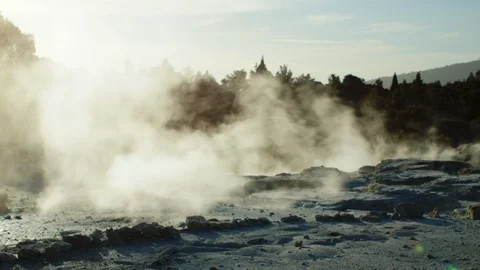Panning shot right to left of steaming geysers in Rotorua, New Zealand Stock Footage 89594483