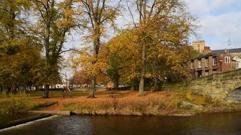 Panning shot of river skell flowing by ripon cathedral yorkshire uk Stock Footage 119061103