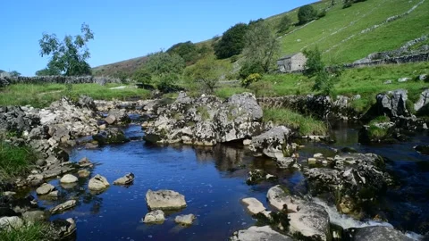 Panning shot river wharfe flowing through langstrothdale yorkshire dales uk Stock Footage 154456423