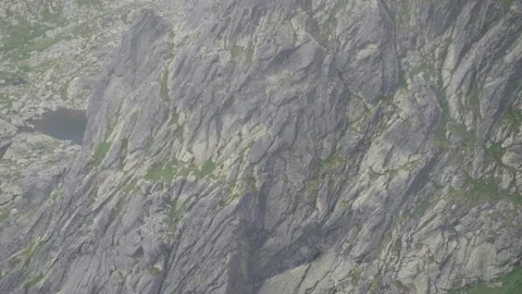 Panning shot of rock surface with vegetation, Tatras, Slovakia. 4k Stock Footage 168346721
