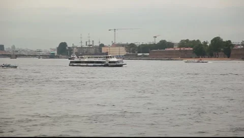 Panning shot of the ship on the Neva river, then tilt to petropavlovka spire Stock Footage 7340252