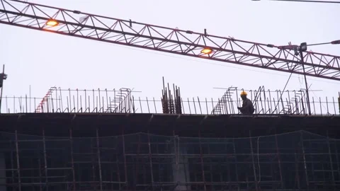 Panning shot of silhouette of men construction workers labor wearing protective Stock Footage 147245604