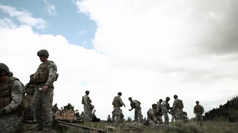 Panning shot of soldiers assembling a mortar launcher and aiming another. Stock Footage 52703106