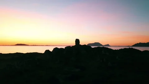 Panning Shot Of Stack Of Rocks On Mountain Landscape By Sea During Tranquil 스톡 동영상 233998049