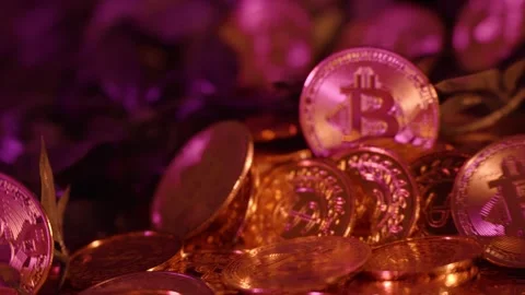 Panning shot of stashes of golden bitcoin coins on show in a portfolio Vídeos de archivo 287304592