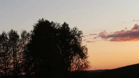 Panning shot of Sunset, clouds and horizon silhouette HD Stock Footage 134738055