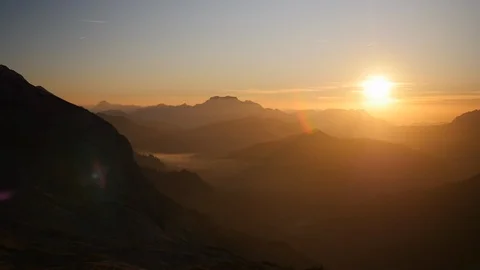 Panning shot a sunset mountain scape left to right golden hour in altitude Stock Footage 87695642