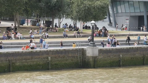 A panning shot of the Thames Riverside with lots of tourists in the summertime. Stock Footage 281787430