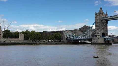 Panning shot from Tower Bridge to Tower of London across River Thames Stock Footage 346677515