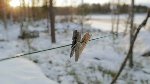 Panning shot of two clothes pins hanging on a wire. Beautiful sunny day. Stock Footage 105007342