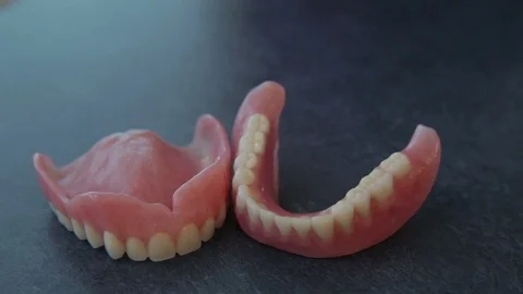 Panning Shot of Upper and Lower Complete Dental Acrylic Dentures Stock Footage 106160898