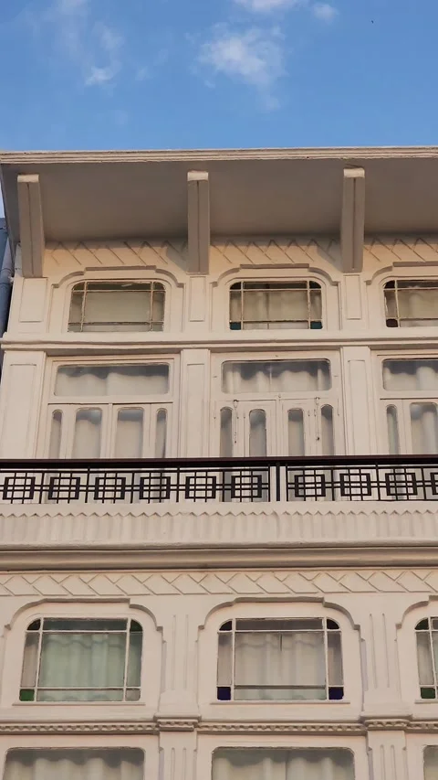 A panning shot of the upper two floors of an old building Stock Footage 314209080