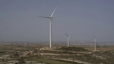 Panning shot of a valley with wind turbines producing energy Stock Footage