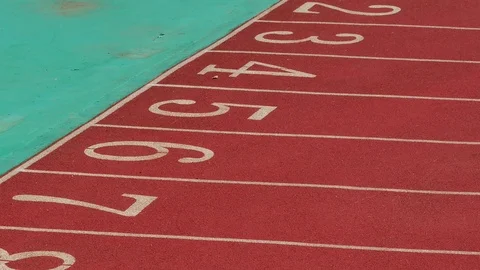 Panning shot. View of numbered running athletics track. Stockbeeldmateriaal 121210556