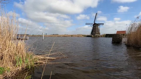 Panning Shot Windmill Across A Canal Through in the Netherlands Stock Footage 151990853