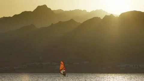 Panning shot of windsurfer on the background of sunset mountains. Dahab, Egypt Stock-Footage 164648847