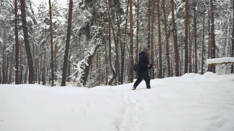 Panning shot in winter mountains. Man with camera is going to take a photo af Видео 101117880