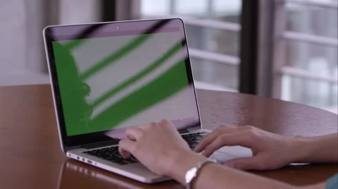 Panning shot of woman using computer with green screen. Stock Footage 50496101