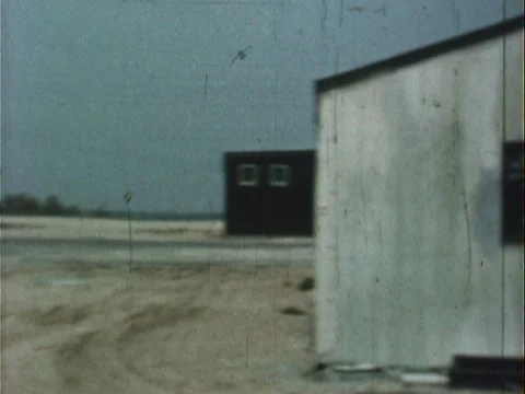 Panning shots of empty army base and barracks - vintage 8mm Stock Footage 79267897