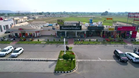 Panning sideway low aerial drone shot showing mix of branded food outlets in Stock Footage 305943736