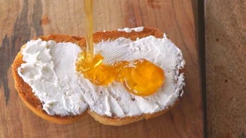 Panning on slice of bread with cream cheese and honey. Stock Footage 104900316