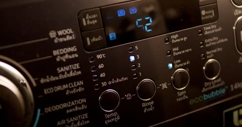 Panning slightly from the left to the right on a washing machine control Stock Footage 277199824