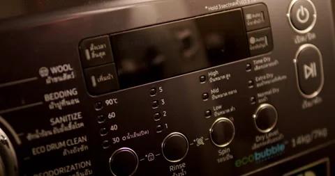 Panning slightly from the left to the right on a washing machine control Stock Footage 278143930